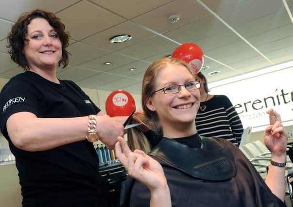 Lyndsey Lee prepares to have her hair cut by Carol Brown for charity                                                    L10603H14