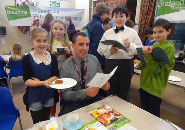 Maddie Ely, Isabel Kelly, Hannon Talbot, Santi Deleze serving Morgan Rees, Kavanagh's Budgens Store Manager at the Year 6 French Cafe SUS-141103-104608001