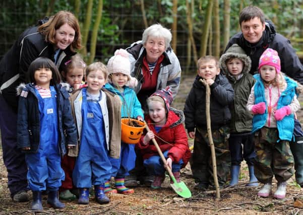 JPCT 070314 S14110156x Playgroup from Holy Trinity Church, Rushams Road, Horsham, planting oak tree seedlings at their outdoor club in woodland area off Hammerpond Road. -photo by Steve Cobb SUS-140703-112313001
