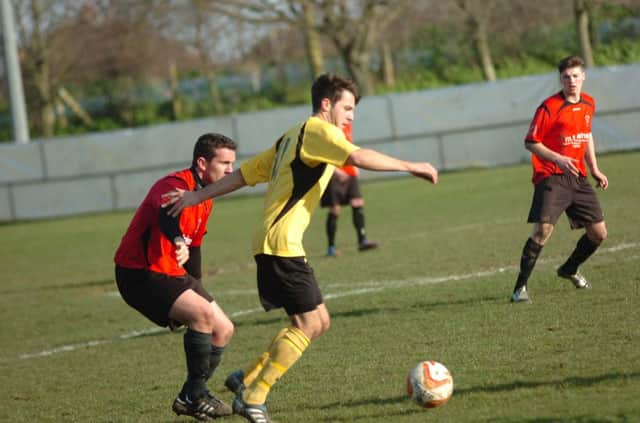 Rye United midfielder Anthony Storey keeps a close eye on a Hassocks opponent during Saturday's 4-1 defeat at The Salts. Picture by Simon Newstead