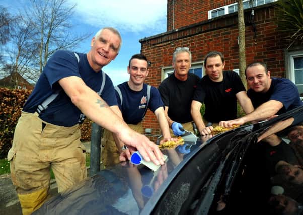 15/3/14- Battle Firefighters washing cars for charity. SUS-140315-165343001