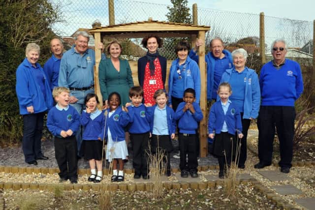 Head Louise Swann and teacher Helen Hunt, centre, with Adur East Lions and pupils in the garden S11250H14
