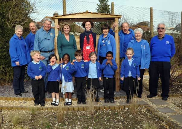 Head Louise Swann and teacher Helen Hunt, centre, with Adur East Lions and pupils in the garden S11250H14