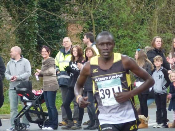 2014 Hastings Half Marathon winner Boniface Kongin heads onto The Ridge having completed the uphill Queensway stretch. Picture by Simon Newstead