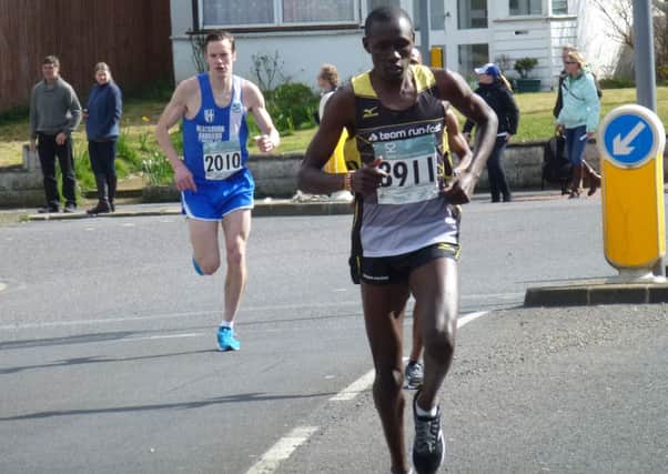 2014 Hastings Half Marathon winner Boniface Kongin leads the way from Ben Fish in the first mile. Picture by Simon Newstead