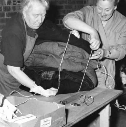 WVS members tie up a bundle of clothing