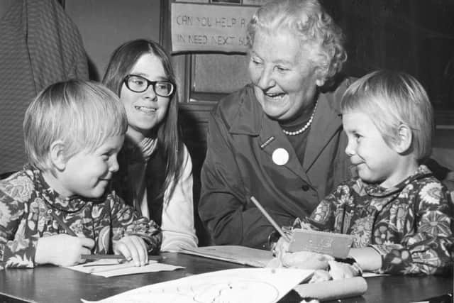 A WVS team organiser with children at a playgroup