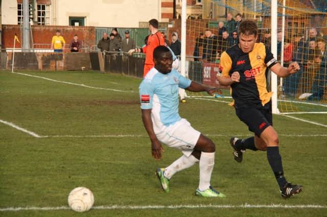 Hastings United winger Bailo Camara tussles with Steve Elliott during the 3-2 defeat to Eastbourne Town on Saturday. Picture by Terry S. Blackman