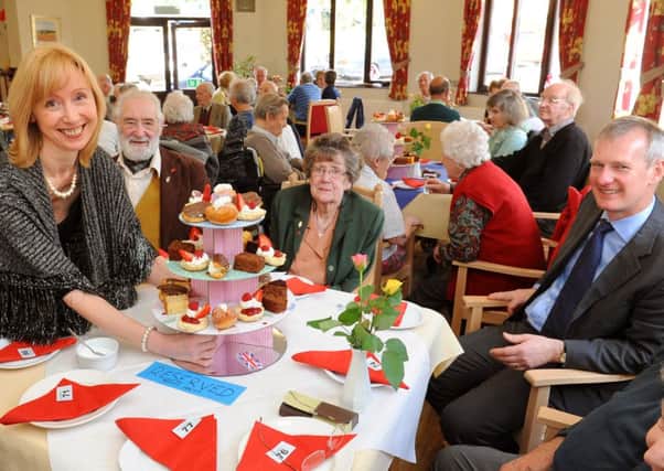 JPCT 190314  Sussexdown Care Home in Storrington puts on Ritz event to join in the National Association of Care Caterings Biggest Tea Party. General manager Heather Rogers with guests from the Royal British Legion. Photo by Derek Martin SUS-140319-175017001