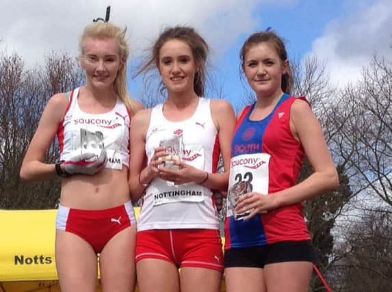 Teenage athletics talent Grace Baker (middle) stands proudly on top of the podium having been victorious for England in Nottingham