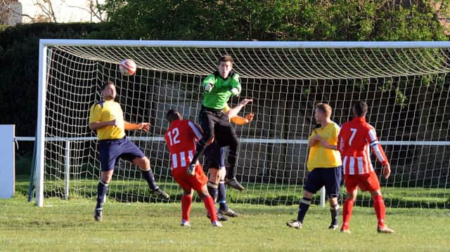 Little Common goalkeeper Jon Saunders punches clear during the 2-0 win away to Steyning Town last weekend. Picture by Stephen Goodger