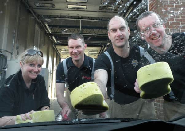 Firefighters get stuck in washing cars for charity                                             L14T1H14