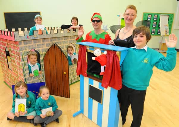 JPCT 280314  Puppet Theatre hand-made by David Salvage, MD and Chief Elf of new business 'I Believe in Faeries' presented to Kingslea Primary School pupil Zac Aguas far right and their school wins a hand-made playhouse. Photo by Derek Martin SUS-140328-121959001