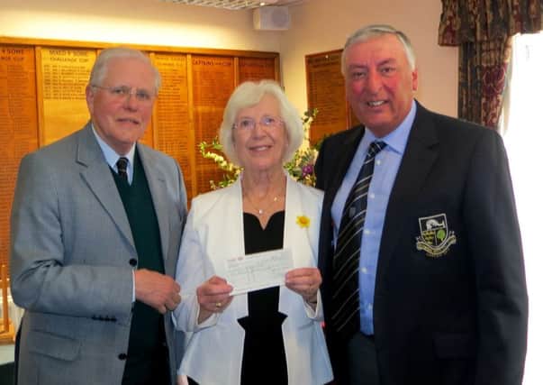 Seniors Captain Gosta Kullner with Ladies Captain Rosmary Parvin and Club Captain Derek May receiving the cheque.