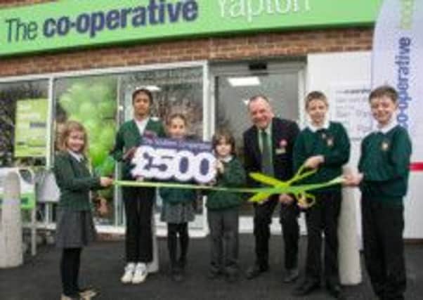 Pupils from the Yapton Primary School reopen the village's new post office and Co-operative store. Pictured with  deputy
retail business manager, Paul Chatfield.