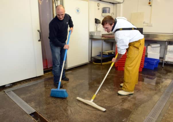 Workers at Littlehampton's Riverside Industrial Estate clearing up after their business was hit by flooding.