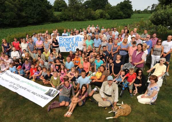 Residents near Penland Farm protest about the plan to build on Penland Farm land, pictured here in the field behind the group ENGSUS00120130511155717