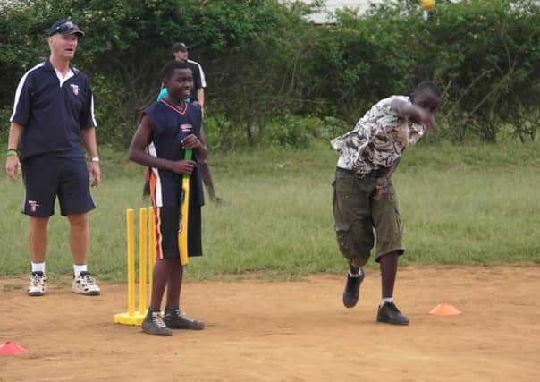 Bob Hopkins (left) in Rwanda with Cricket Without Borders