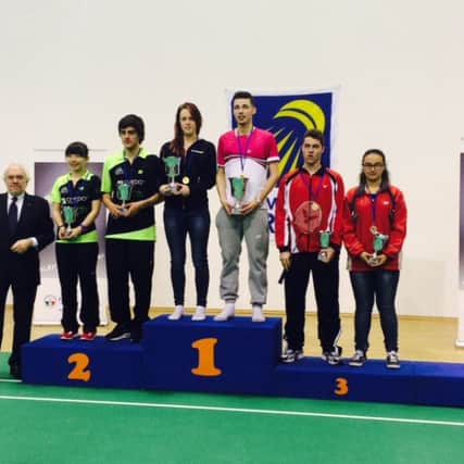 Lydia Powell and Sean Vendy on the top step of the podium after winning the mixed doubles title in Italy
