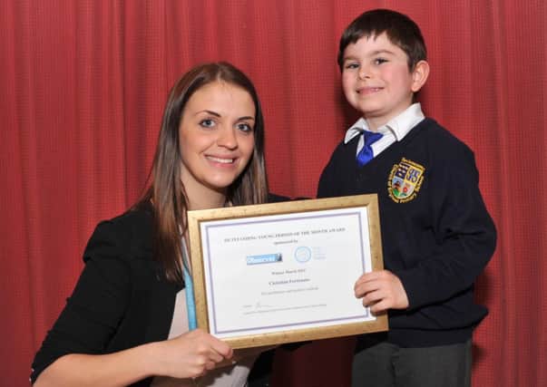 28/3/14- Lauren Fry from Sussex Coast College presents the Outstanding Person of the Month Award to Christian Fortunato SUS-140328-114953001