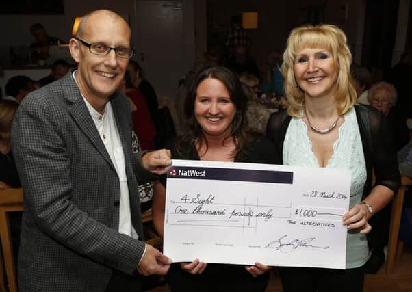 Members of 4Sight receive their charity cheque from charitable Arundel rock band The Alternatives