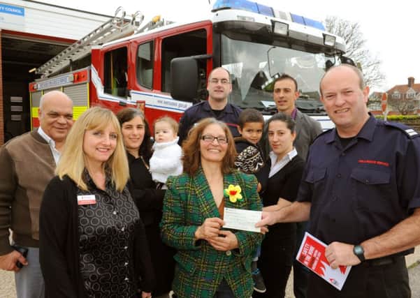 Maria Moniz presents the cheque to Crew Manger Graham Lincoln and Jeanne D'Amario from The Fire Fighters charity