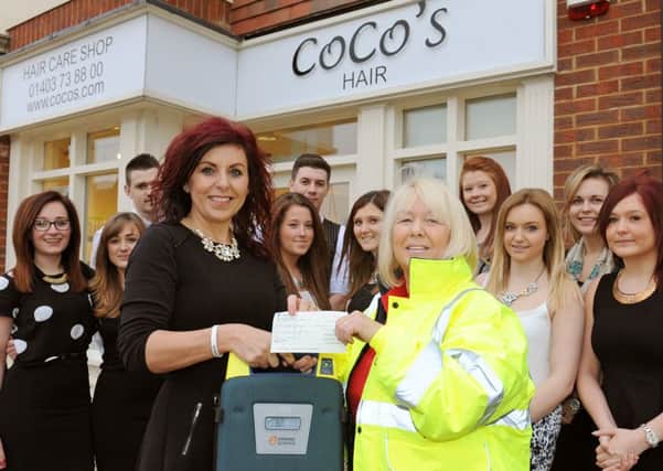 JPCT 240114 Cheque presentation fron Coco's hairdressing salon, Southwater to Southwater First Responders. Debbie Coco preents the cheque to Pauline Flores-Moore. Photo by Derek Martin ENGPPP00320140124115416