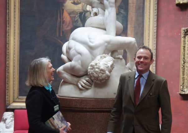 Debbie Wright, Petworth House visitor guide, with Nick Herbert MP in the North Gallery in front of John Flaxman's sculpture 'St Michael overcomes Satan'