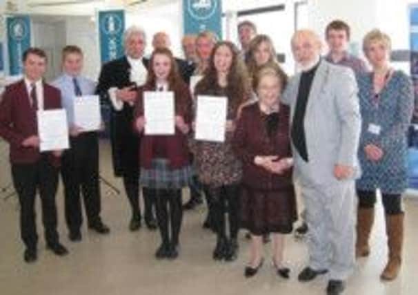 Battle Abbey School students, Ollie Grainge and Isobel Richardson (Year 10), were presented with certificates naming them as 'Young Artists in Residence' at the Conquest Hospital Hastings. Pictured with the High Sheriff of East Sussex Graham Peters and 94-year-old Dame Fanny Waterman who was one of this country's leading piano teachers. SUS-141004-090215001