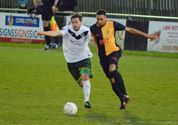 Horsham midfielder Ross Morley battles for possession against Eastbourne. Below Ashley Robinson playing against his former side. Pics by Stephen Curtis