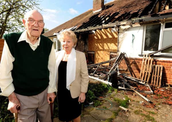 Mathew Hodgton's bungalow in Burgess Hill was severly damaged by fire. Pictured here with Cllr Anne Jones. Steve Robards SUS-141004-163554001