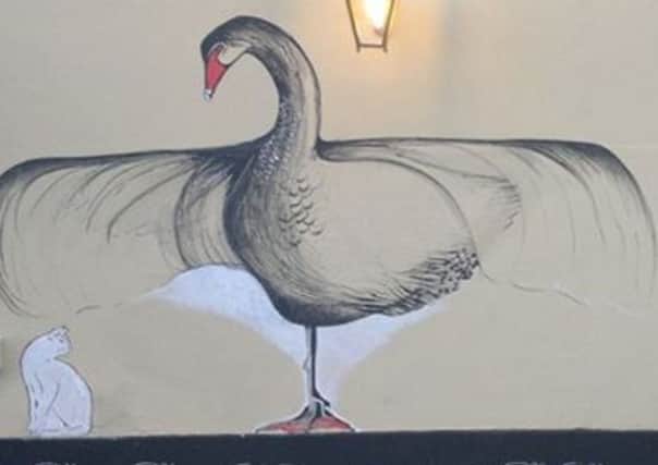 The Black Swan painted onto a wall of the Swan Hotel, in Arundel; a painting deemed offensive by a local resident which Arun District Council has now asked to be removed