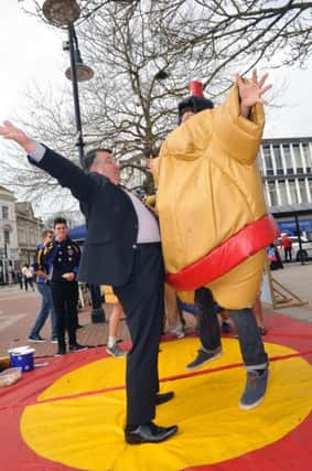W15948H14

Youth Sporst Try out Day in Worthing Town Centre on Saturday. Worthing Mayor Bob Smytherrman Tries his hand wrestling SUS-140414-114921001