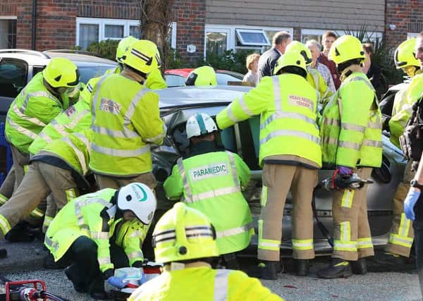 The emergency services worked to free a woman trapped in the Peugeot 206