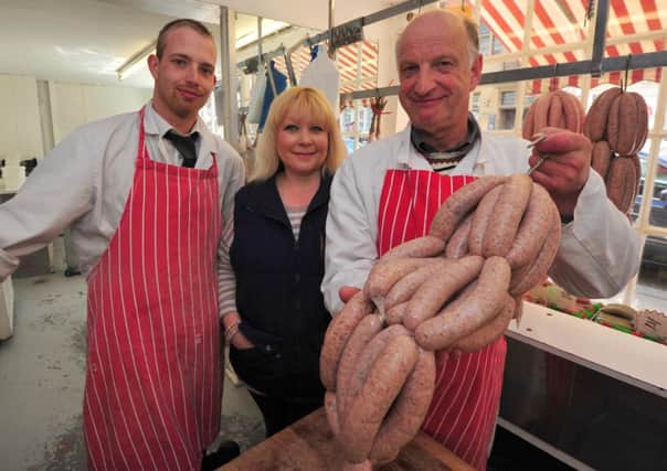 15/4/14- Award-winning Battle Bangers at 1066 Butchers in Battle.  Alistaire and Petrina Ray with Robert Pagan SUS-140415-170155001