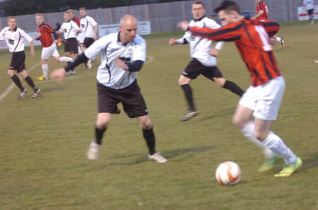 Bexhill United defender Stuart Lewis closes down an Oakwood opponent at The Oval last night