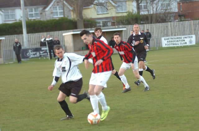 Bexhill United full-back Steven Earley keeps a close eye on an Oakwood opponent. Picture by Simon Newstead