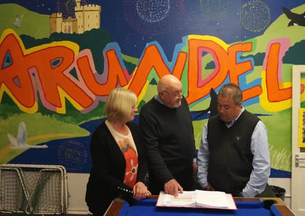 Arundel Youth Club campaigners Lynn Kendall, David Wood and Arundel Mayor Michael Tu examine correspondence from West Sussex County Council about the closure of the club
PHOTO: Mark Phillips