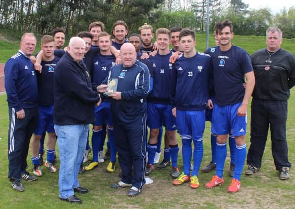 Manager Steve Painter receives his manager of the month award for March from Peter Down from the SCFL, in front of his Broadbridge Heath squad
