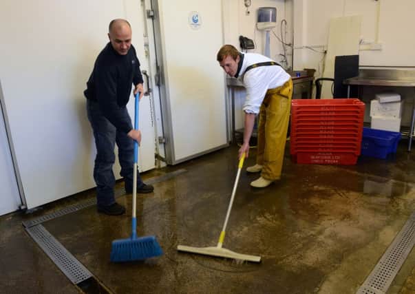 Businesses clearing up after the flooding in Littlehampton last year                                                                                 L50522H13