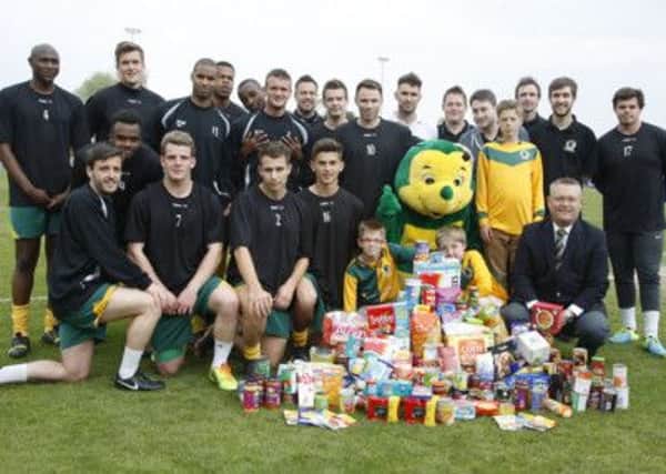 Horsham FC have submitted their planning application. Pictured are the players and chairman Kevin Borrett joining together to help the Trussel Trust Foodbank recently