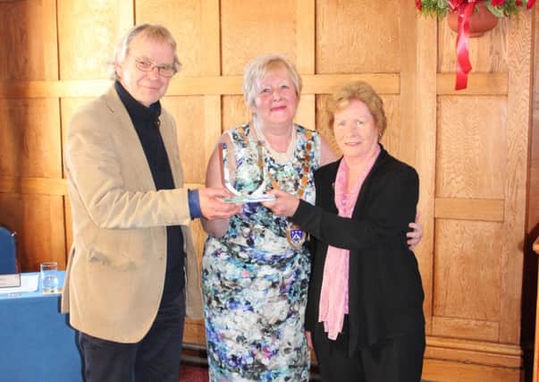 David Twinn, right, and Sue Dyball, left, of Littlehampton Twinning Association pick up their Merit Awards from Littlehampton mayor Joyce Bowyer, centre