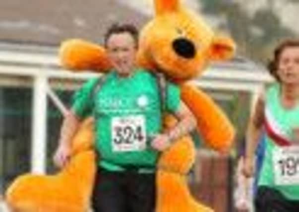 John Alway will run all three legs of the Mid Sussex Marathon Weekend with a teddy bear on his back