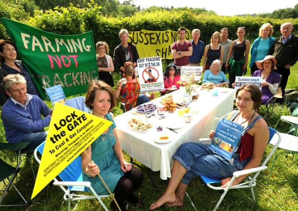 Balcombe residents meet for a tea party on a grass verge opposite the woods at Lower Stumble where Cuadrilla is starting drilling for oil in 2013. ENGSUS00120130618100836
