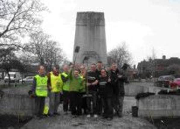 Members of the local Rotary Club join the Cranleigh in Bloom planting team at the War Memorial SUS-140429-111027001