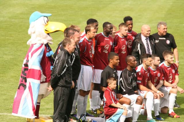 The Hastings United squad lines up for the camera with Leonard the Seagull prior to Saturday's win over Crawley Down Gatwick. Picture by Terry S. Blackman