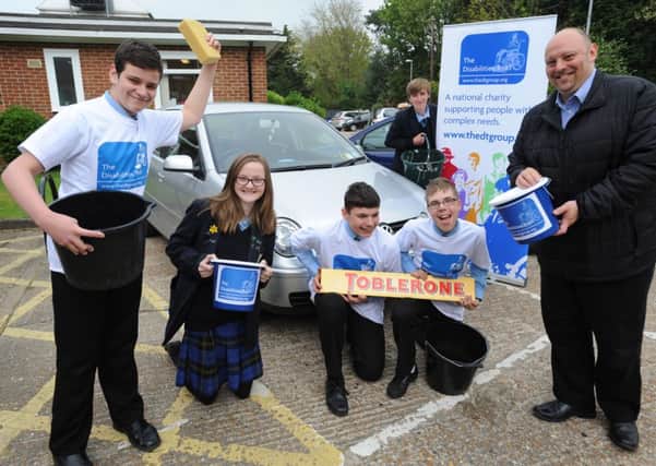 Warden Park pupils helped raise money for The Disabilities Trust, pictured here with their Marketing Officer Charlie Price. Pic Steve Robards SUS-140429-131448001