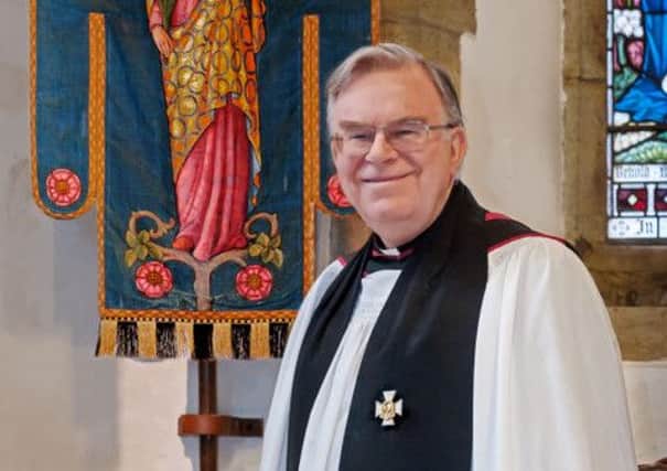 Rev. Malcolm Acheson with the Storrington Church Banner SUS-140429-161637001