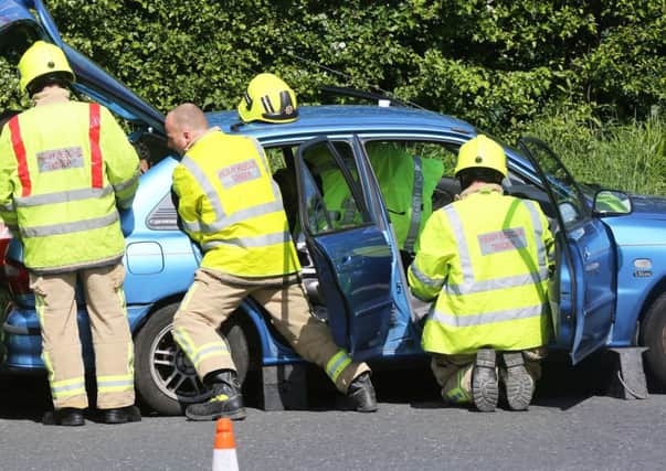 Firefighters working to free the trapped woman from her car   PHOTO: Eddie Mitchell