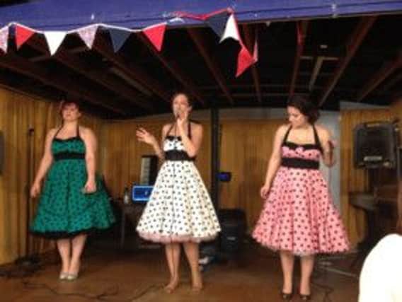 Singers perform at a vintage tea party